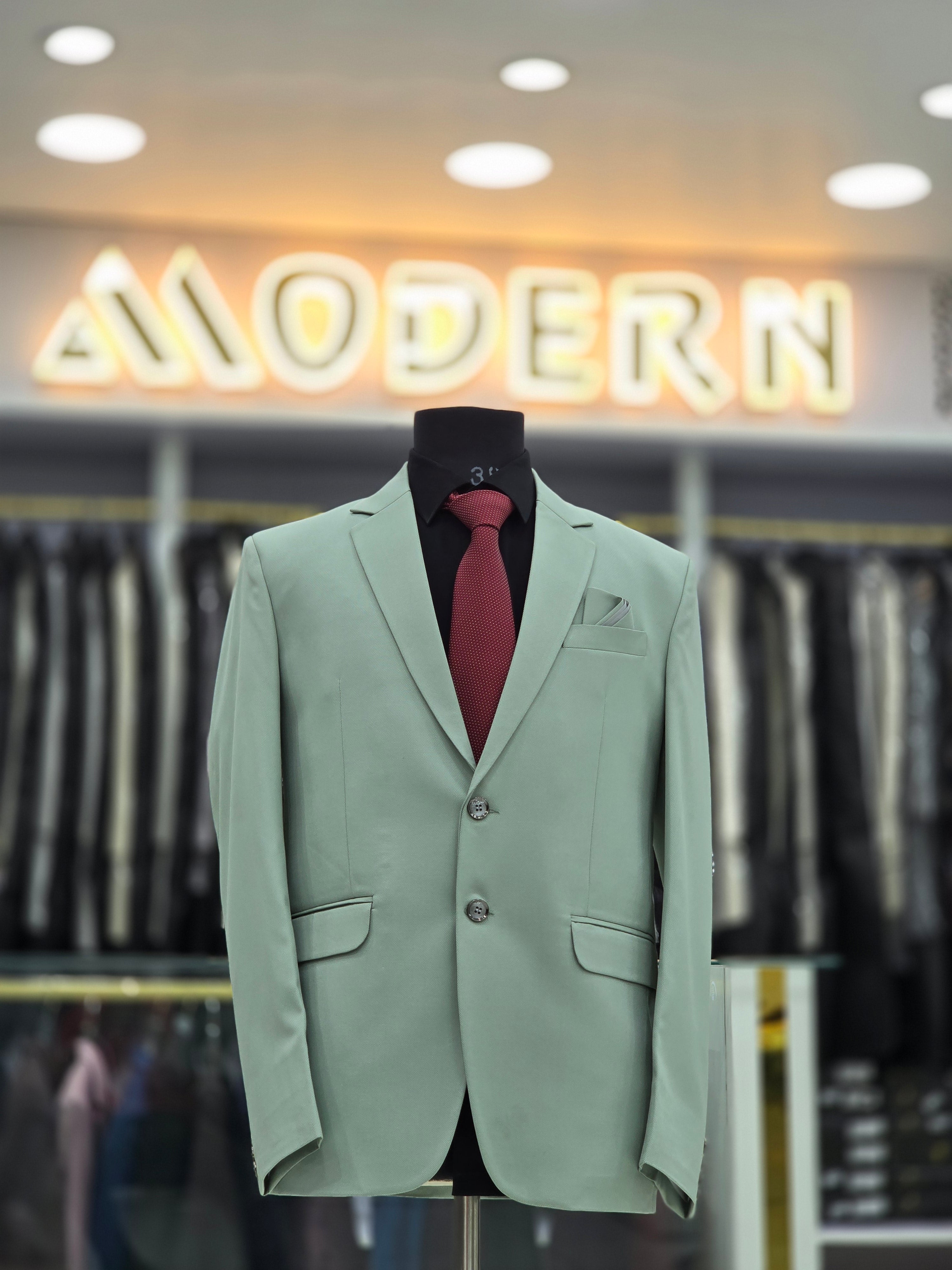 Elegant green coloured formal two piece suit with pants and blazer