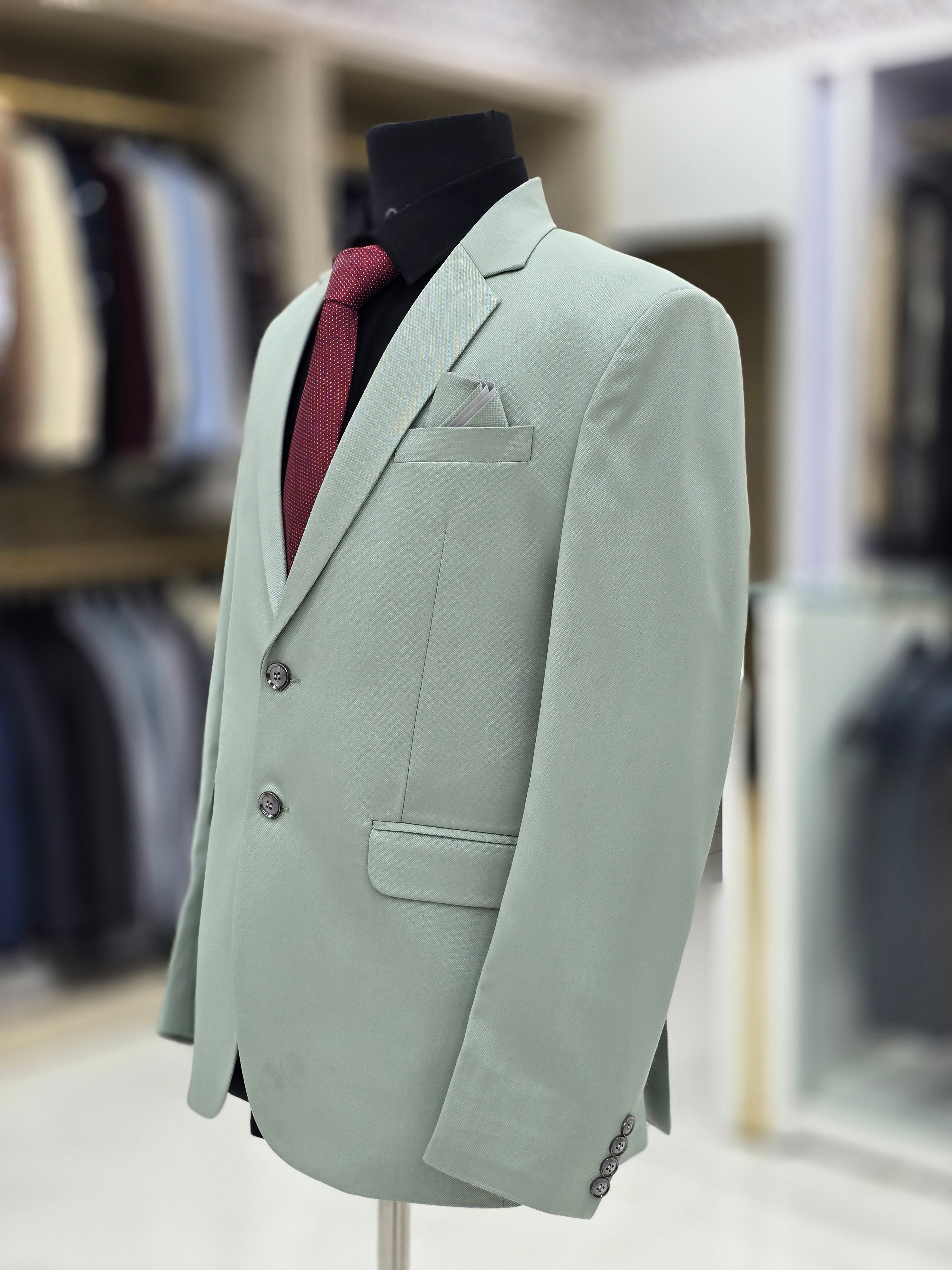 Elegant green coloured formal two piece suit with pants and blazer