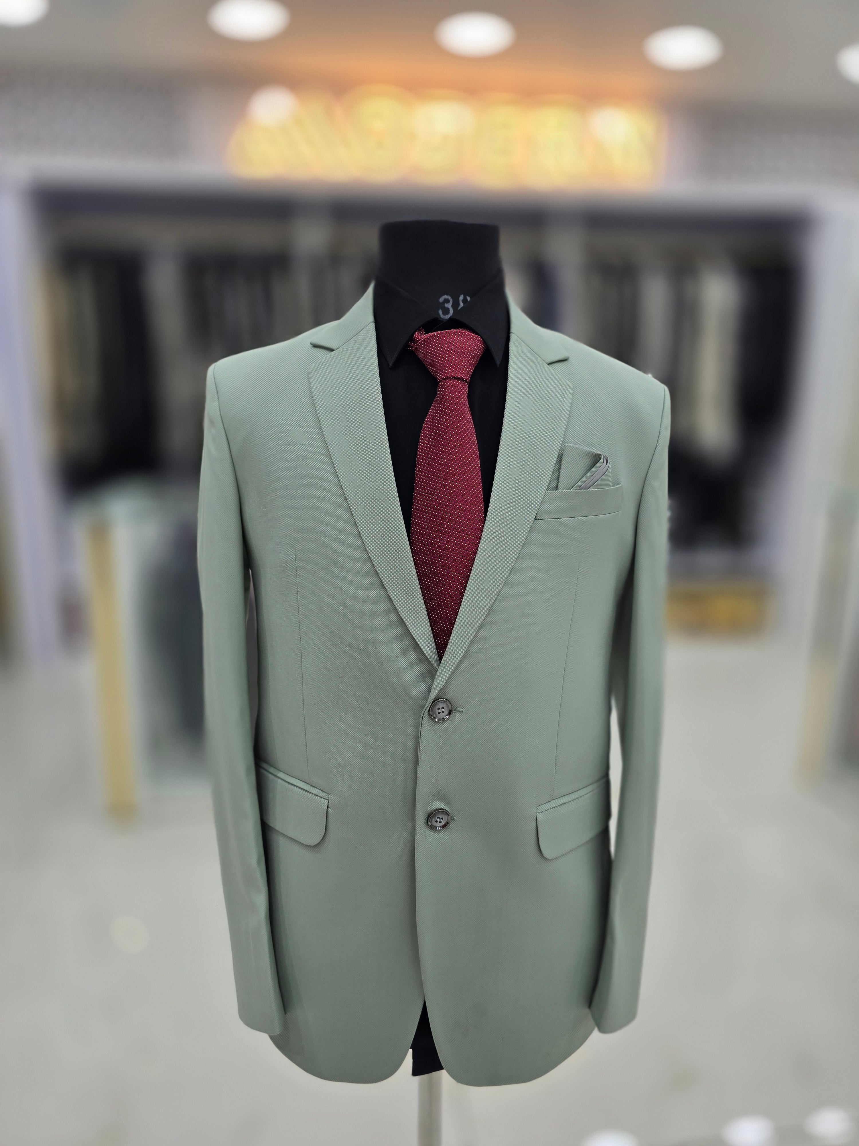 Elegant green coloured formal two piece suit with pants and blazer