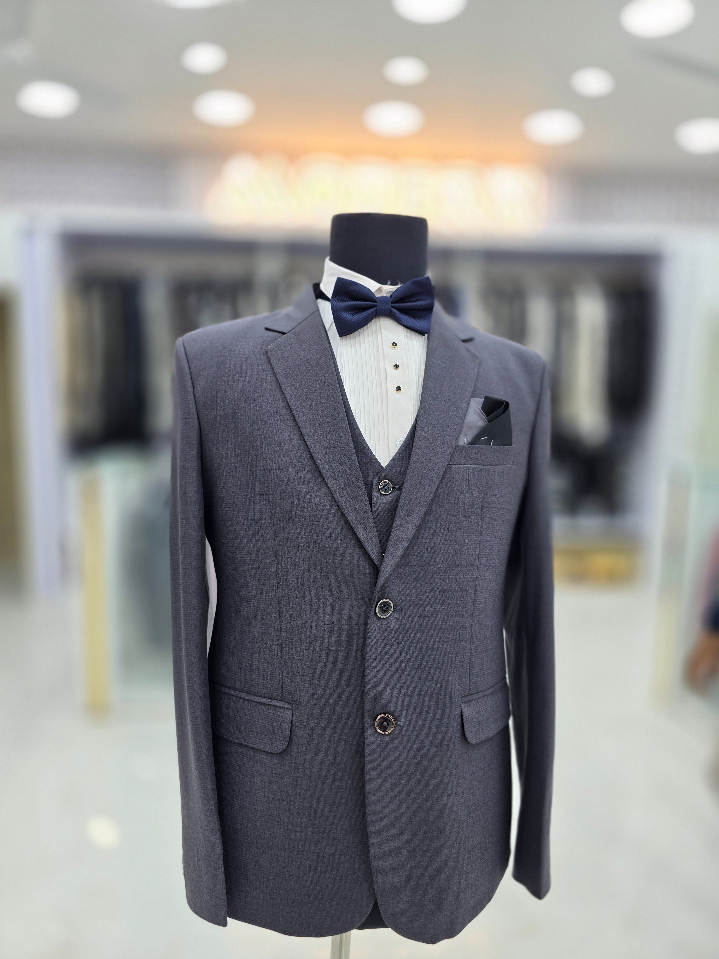 English grey coloured self design formal suit 3 piece with blazer pants and waistcoat