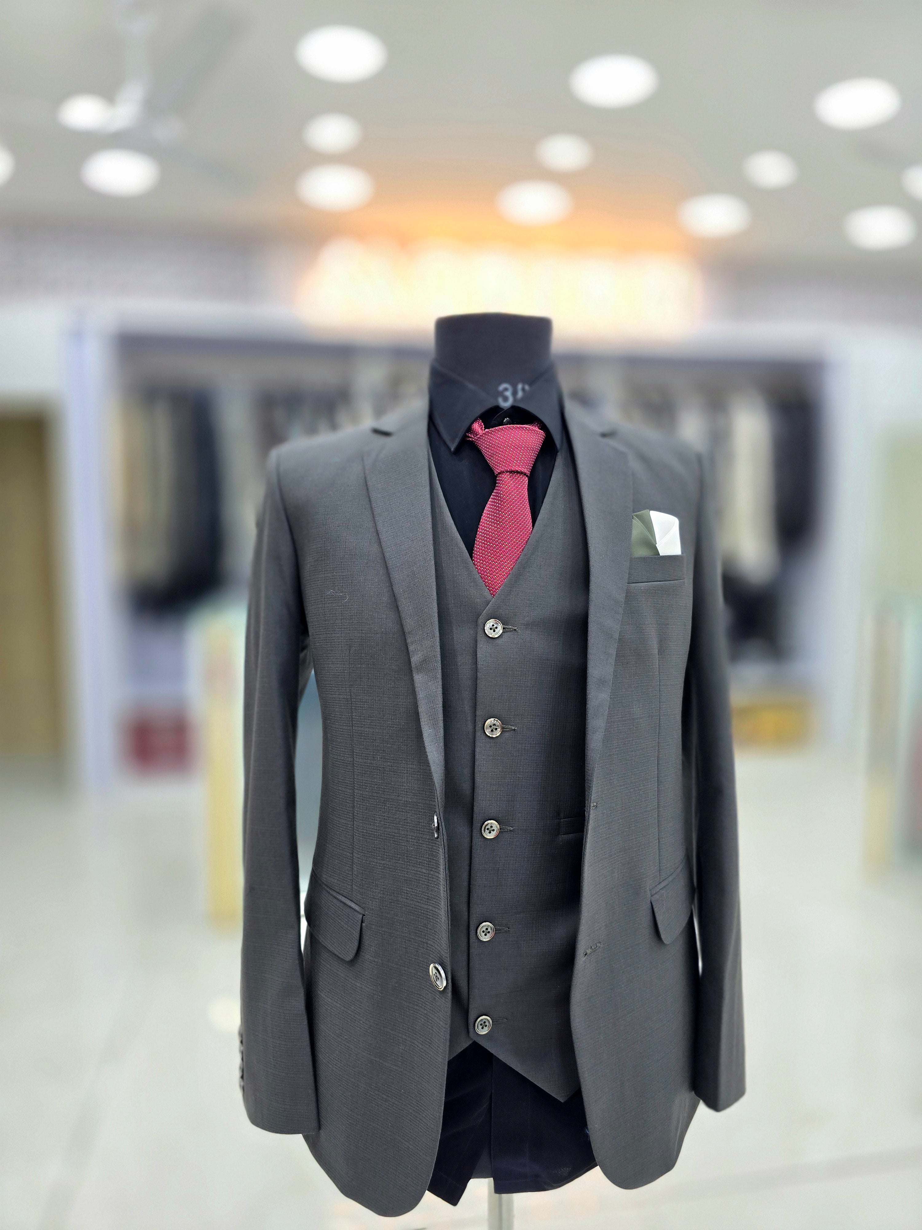 Classic grey formal three piece suit with blazer pants and waistcoat