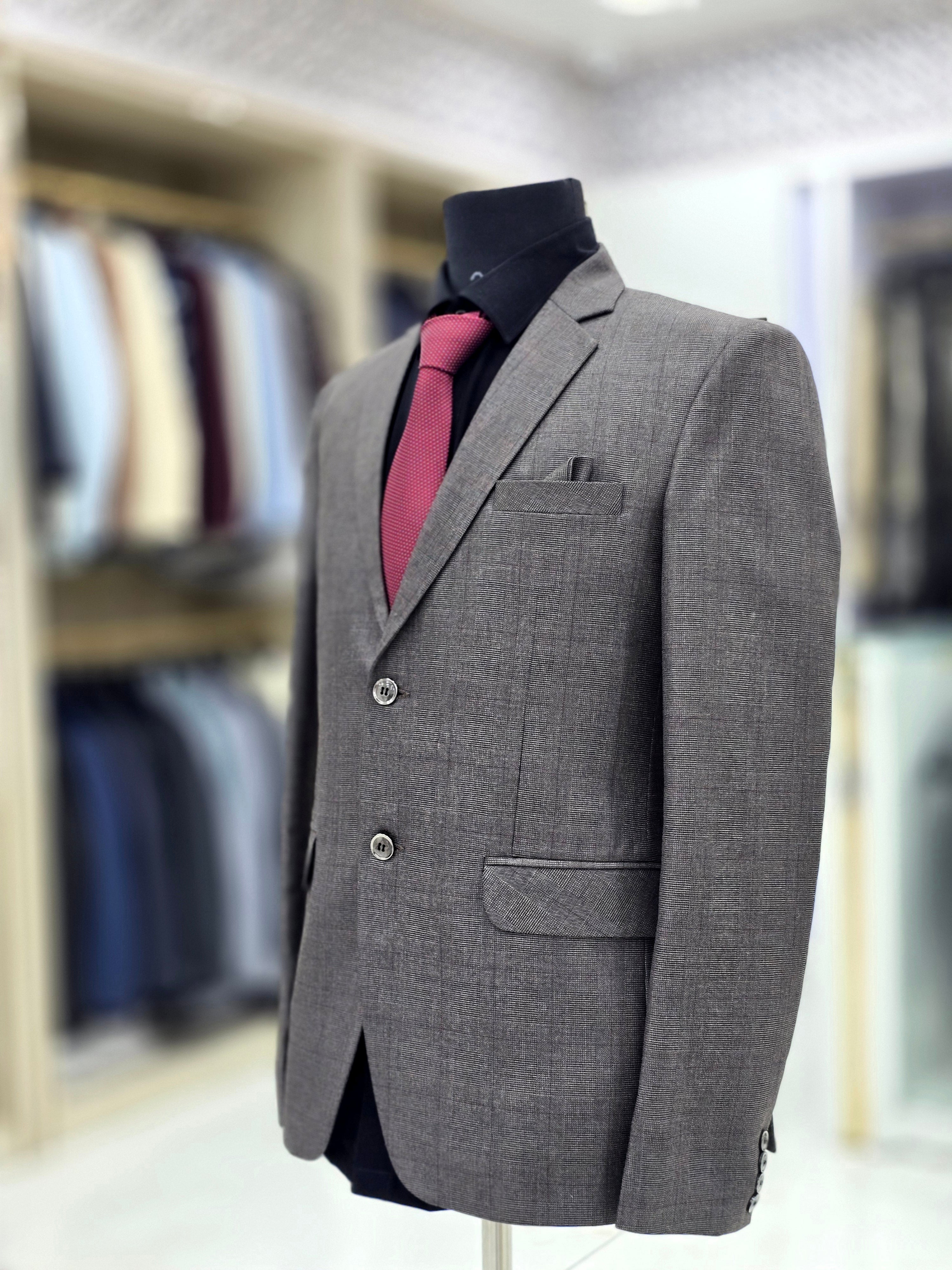 Classic charcoal greyish brown coloured formal two piece suit with pants and blazer