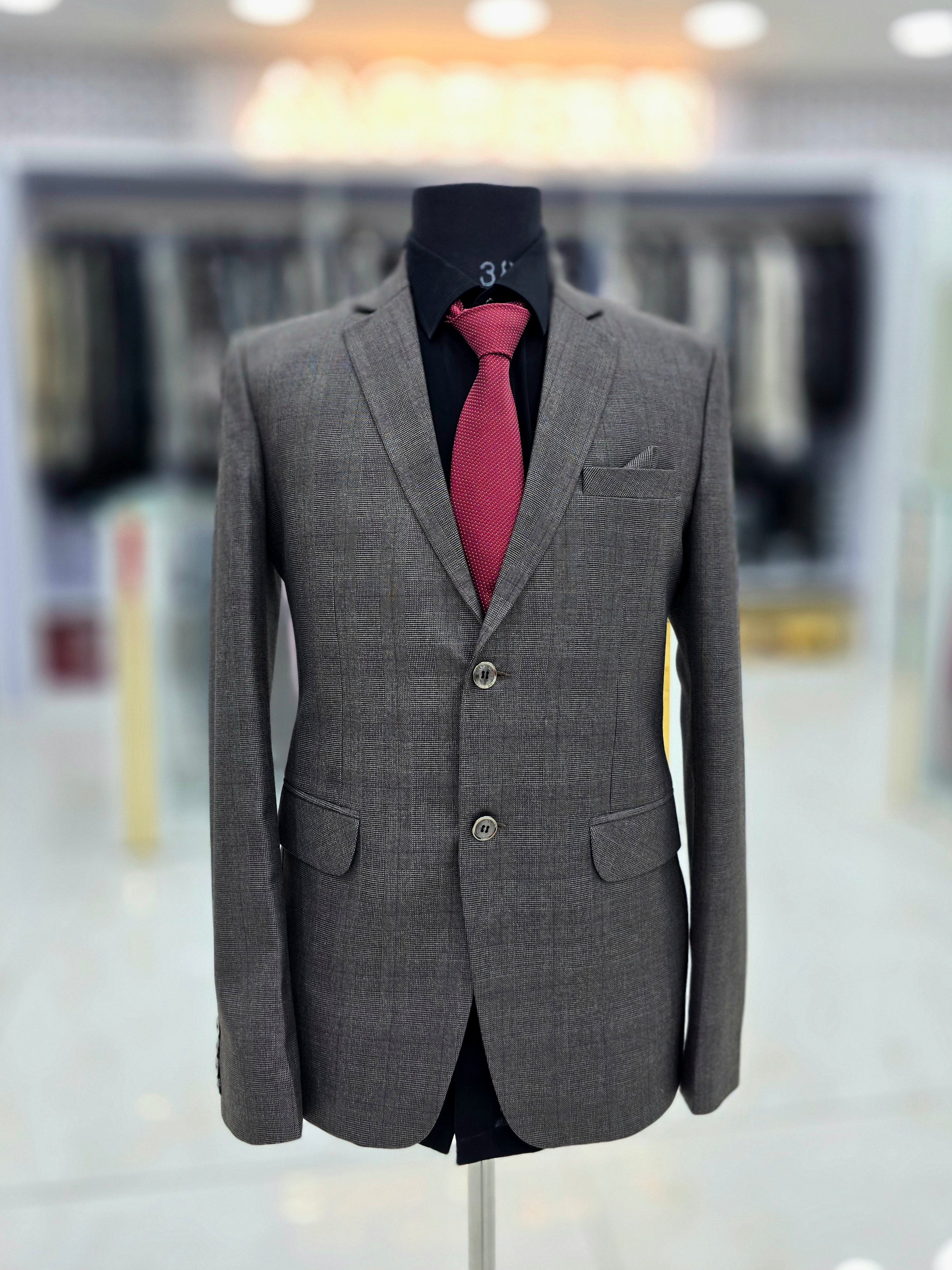 Classic charcoal greyish brown coloured formal two piece suit with pants and blazer
