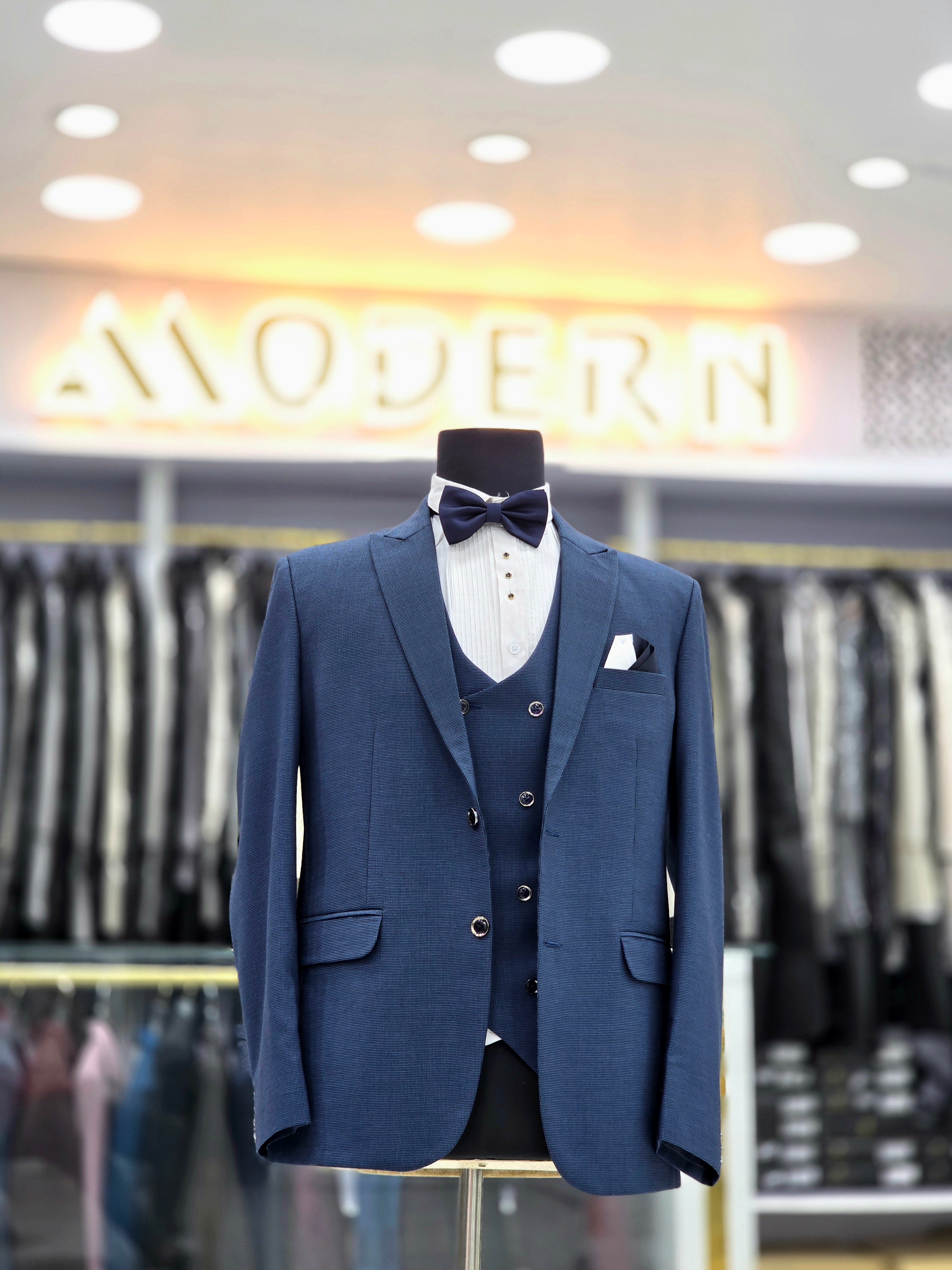 Classic english blue formal three piece suit with blazer pants and waistcoat
