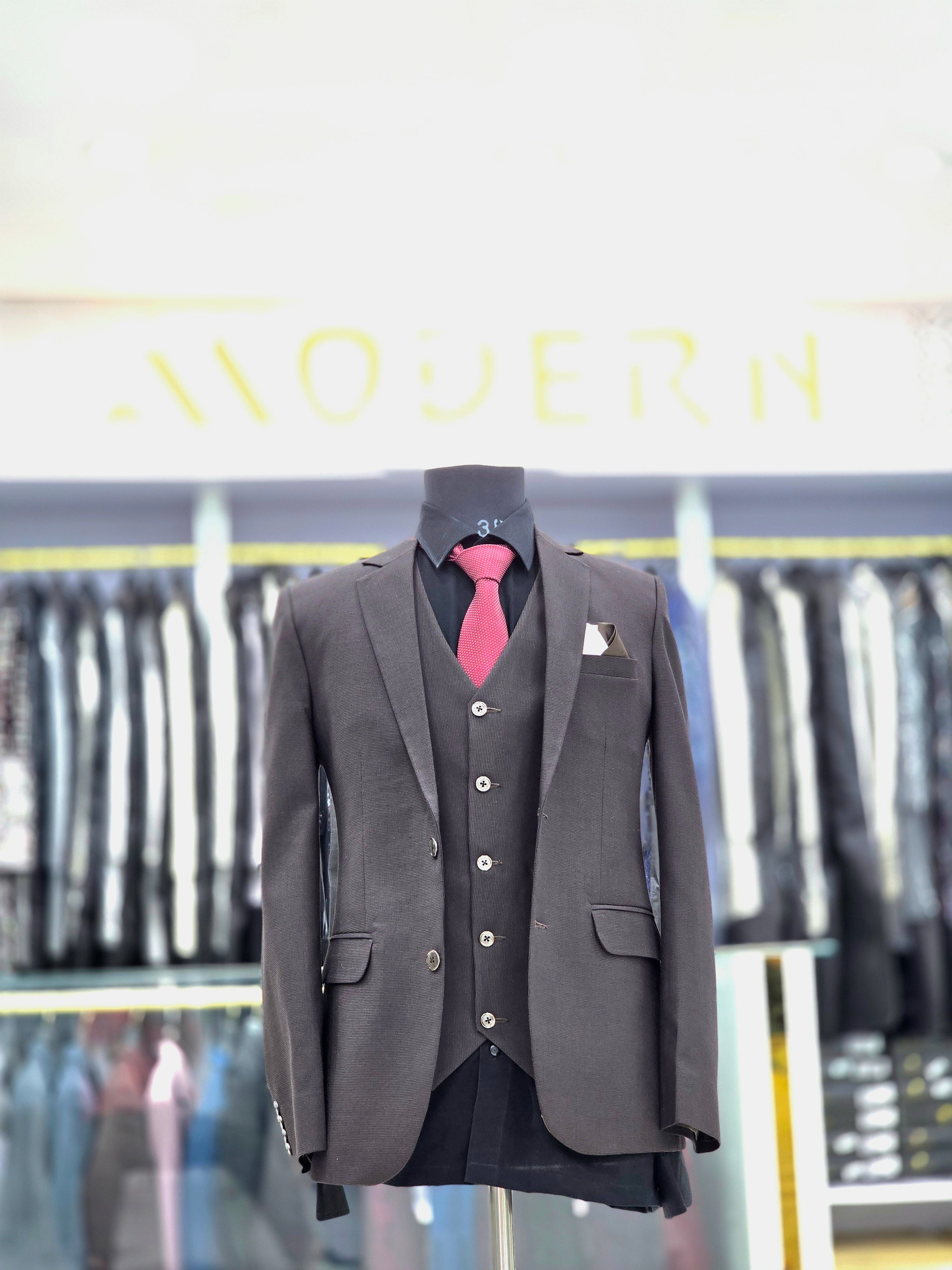 Solid brown coloured formal three piece suit with self design with pants blazer and waistcoat