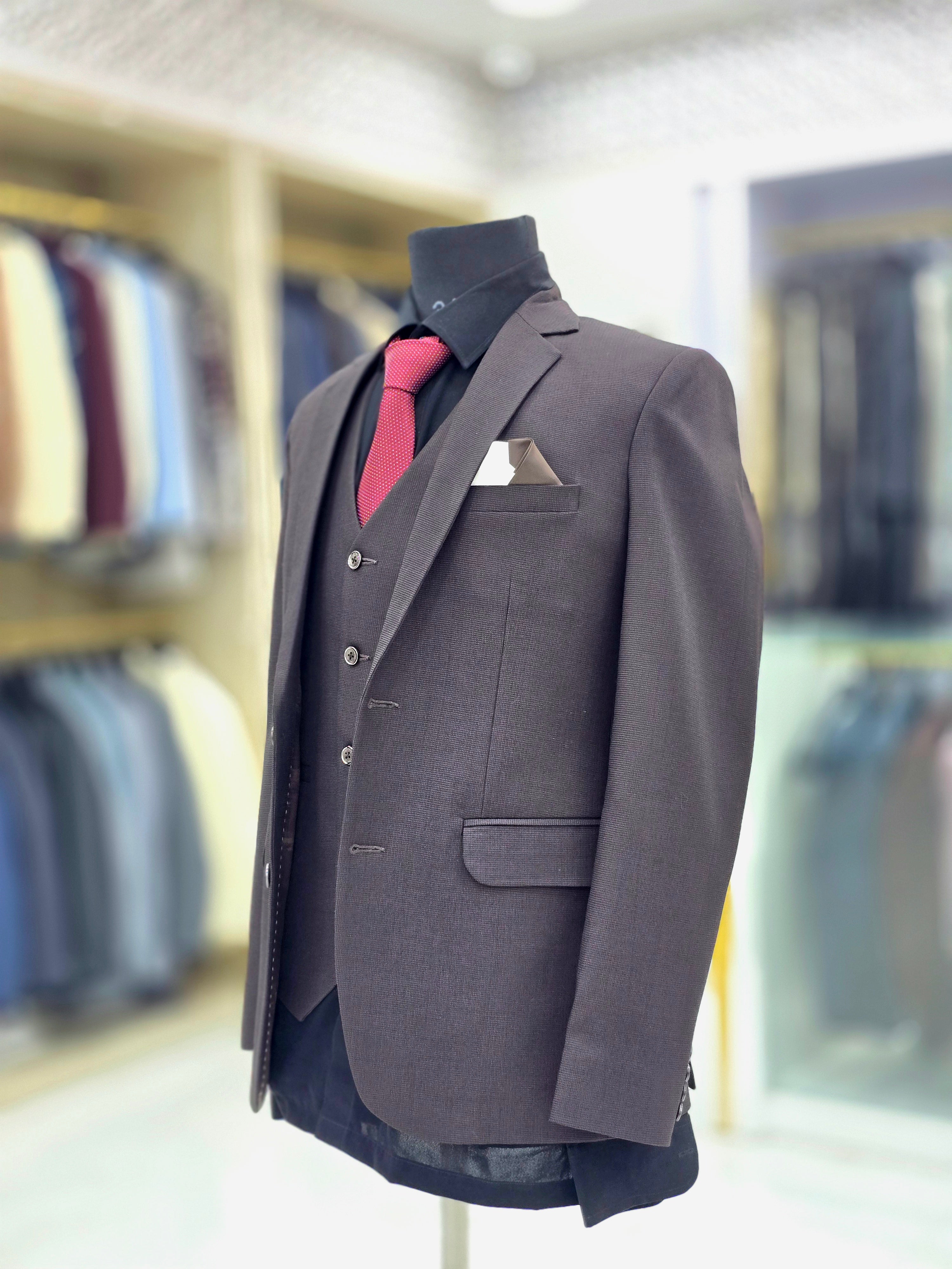 Solid brown coloured formal three piece suit with self design with pants blazer and waistcoat